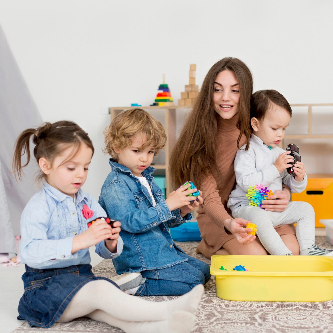 woman playing with children with rubik s cube